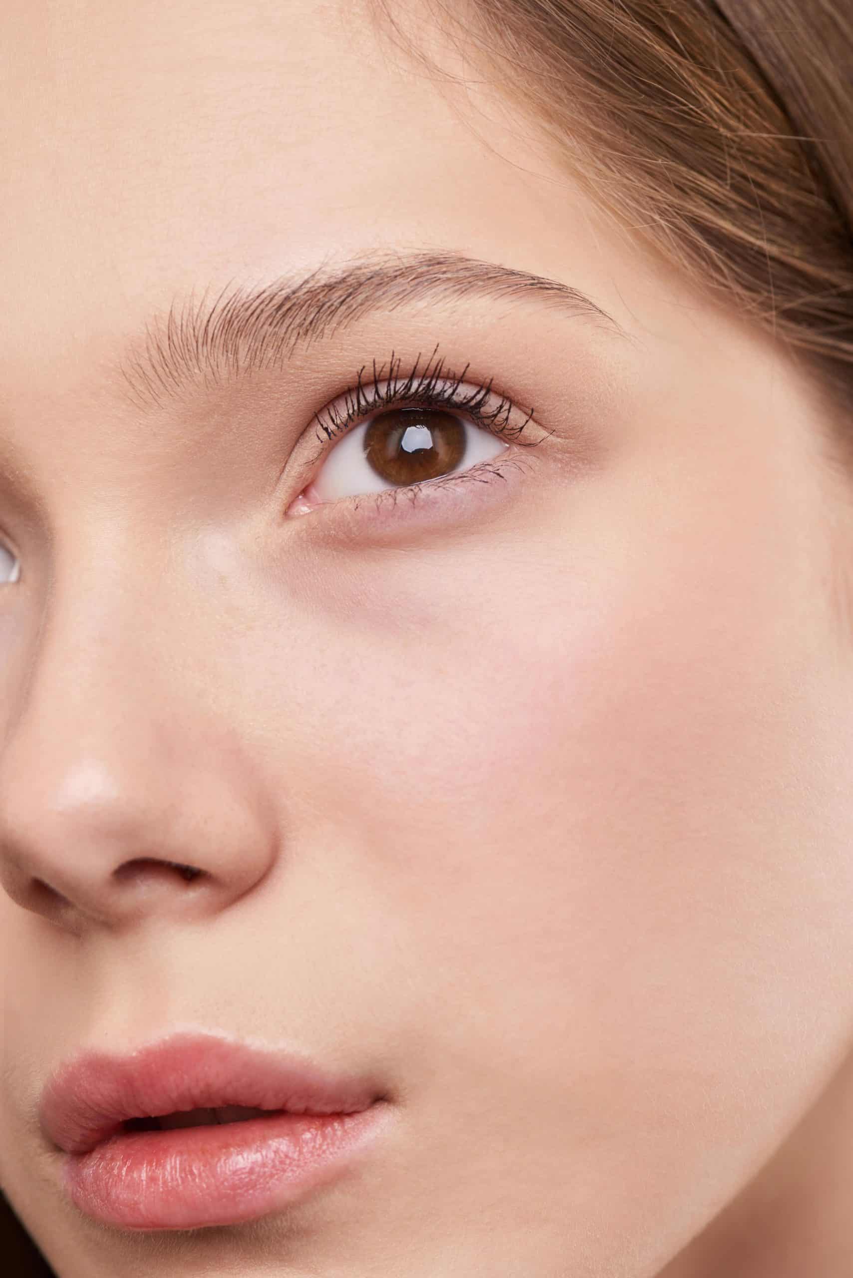 Woman applying rice water toner to face